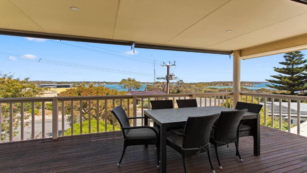 a porch with a table and chairs on a deck at Bimbadeen in Coffin Bay