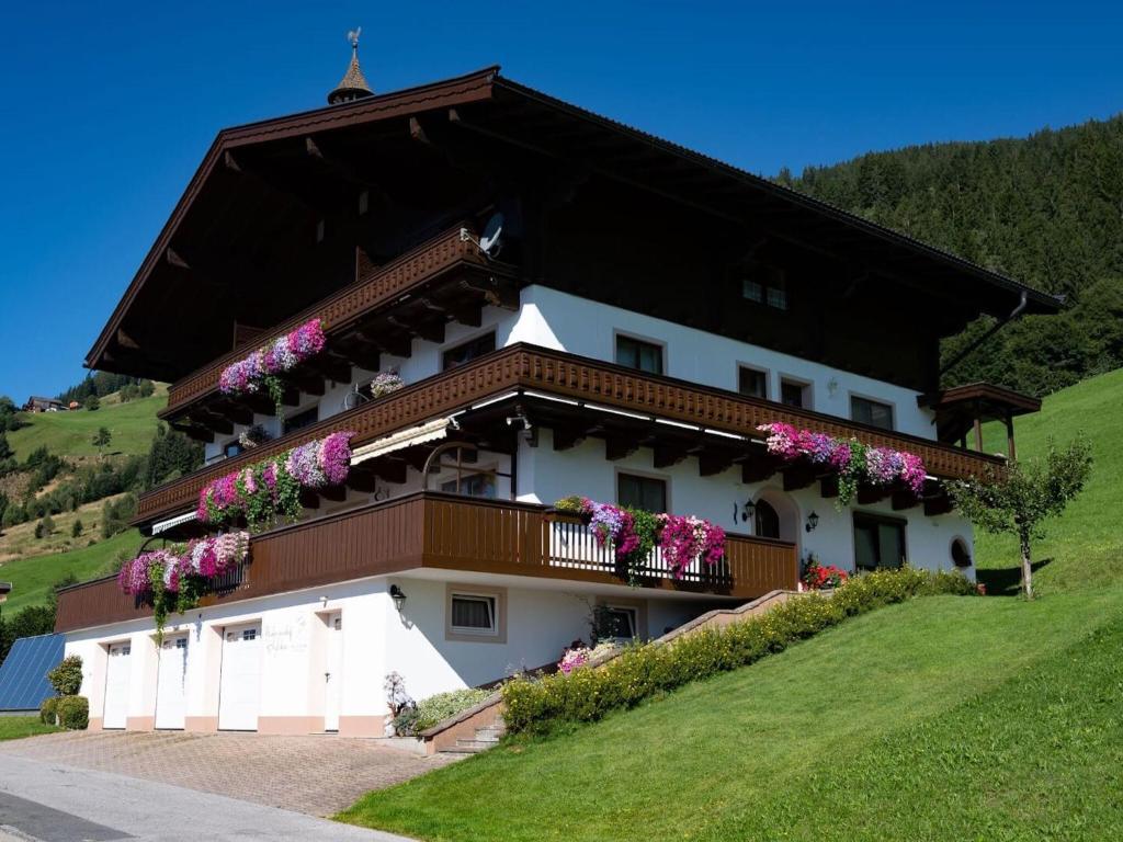 a building with flowers on the balconies on it at Holiday flat with National Park Card included in Dorf