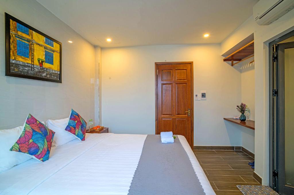 Postel nebo postele na pokoji v ubytování Phuoc Dat Riverside Homestay Hoi An