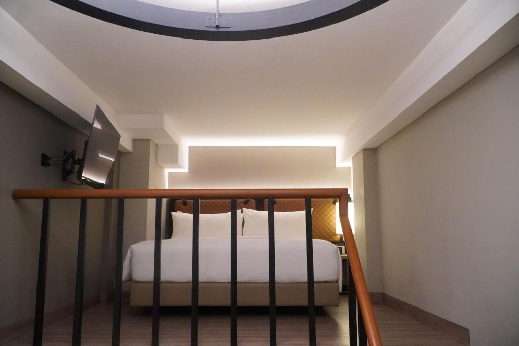 Postel nebo postele na pokoji v ubytování Posto Dormire Sudirman