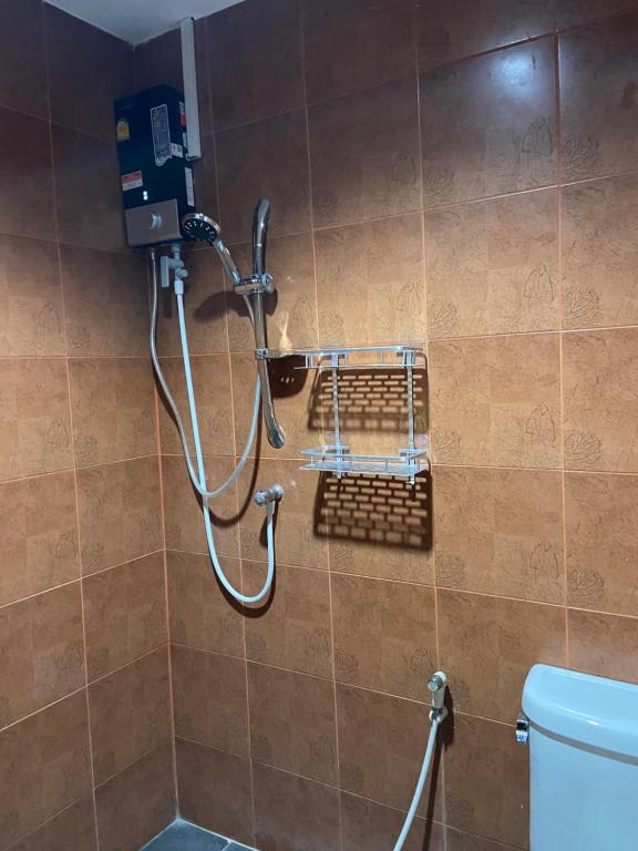 a shower in a bathroom with a toilet at Hua Hin Pool & Spa Villa in Hua Hin