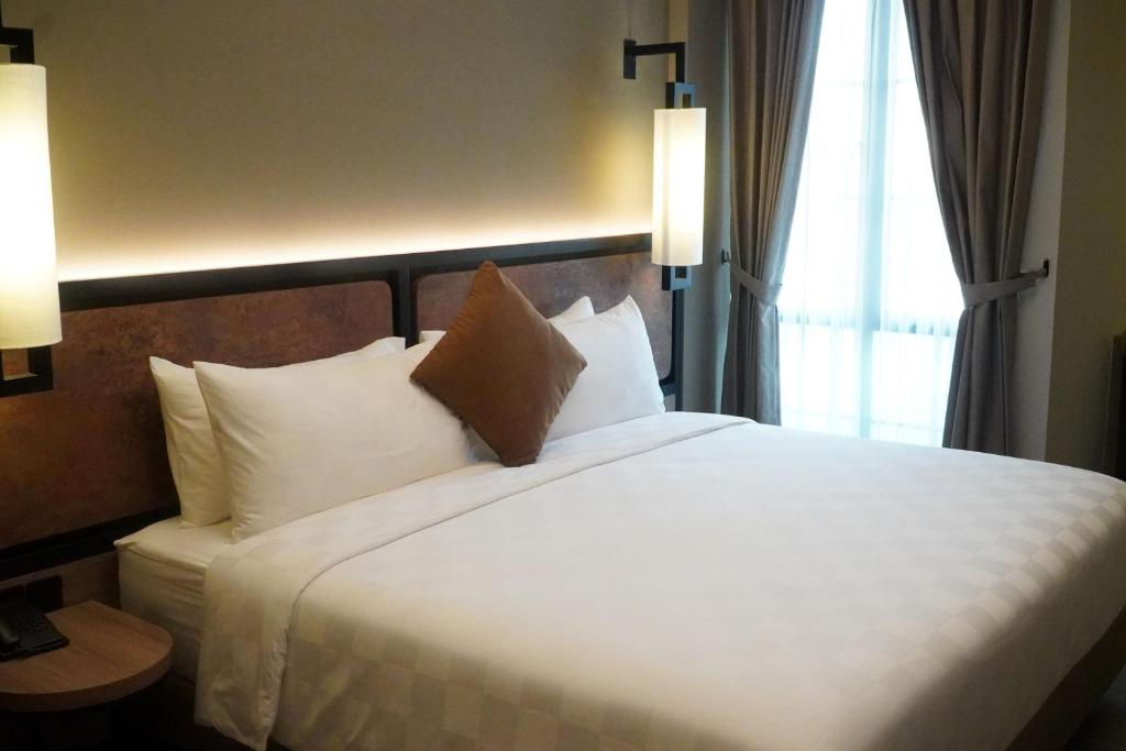 Postel nebo postele na pokoji v ubytování Posto Dormire Sudirman