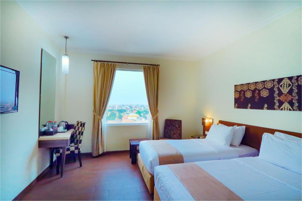 Postel nebo postele na pokoji v ubytování Hotel Dafam Pekalongan