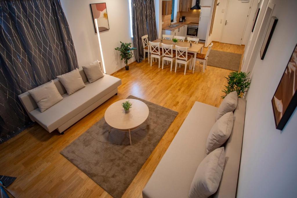 a living room with a couch and a table at NEW East Side Apartment Innsbruck I Free Parking in Innsbruck