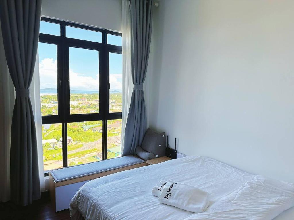 sypialnia z łóżkiem i dużym oknem w obiekcie K Avenue Seaview Nearby Kota Kinabalu Airport w mieście Kota Kinabalu