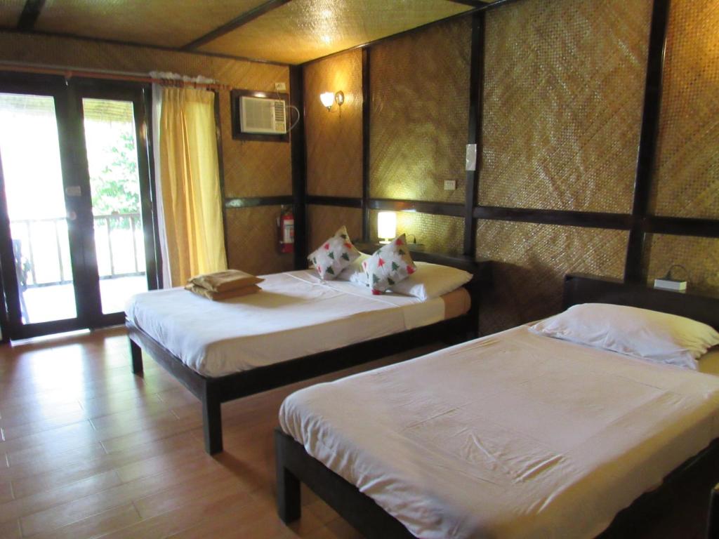 Postel nebo postele na pokoji v ubytování DACOZY Beach Resort