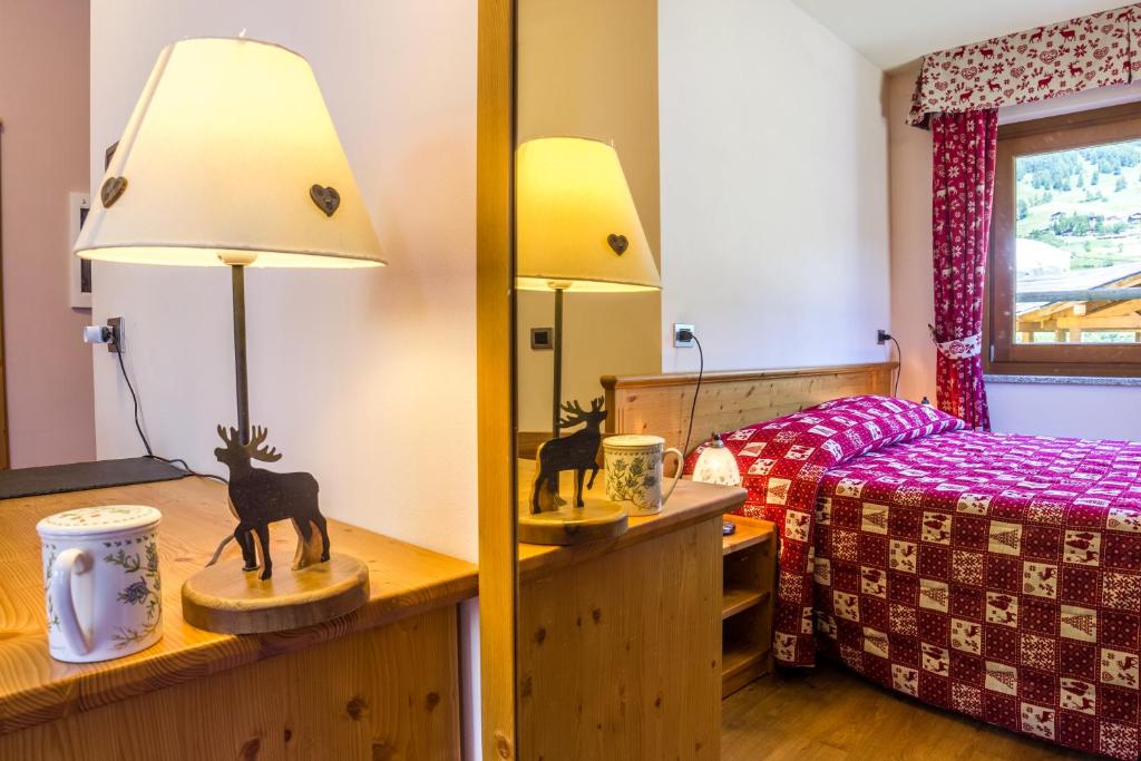 Postel nebo postele na pokoji v ubytování Albergo Punta Zerbion