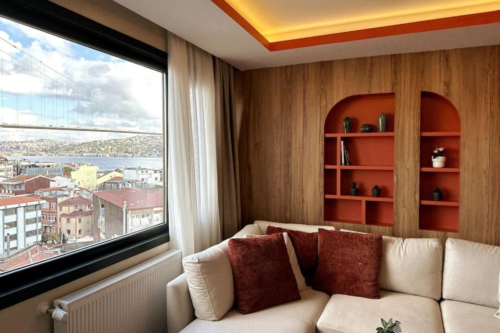a living room with a couch and a large window at Stunning Bosphorus View Daire 12 in Istanbul