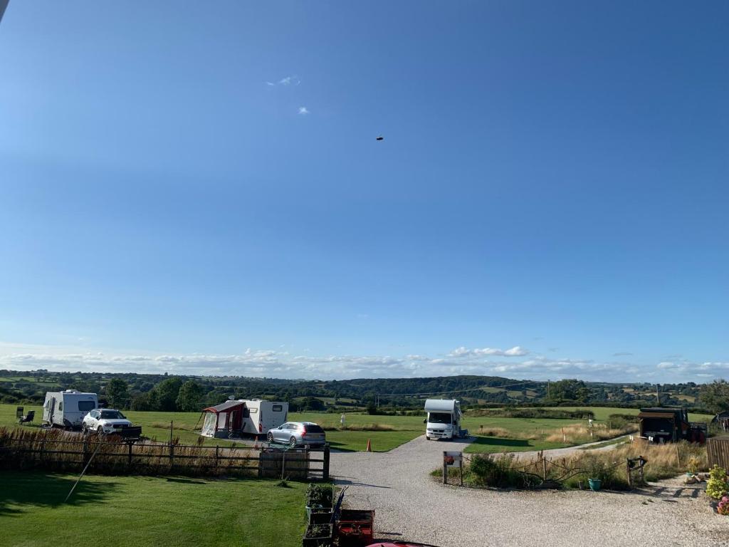 a group of camper vans parked in a field at Poplars Farm Adults only Touring Site empty pitches in Ireton Wood