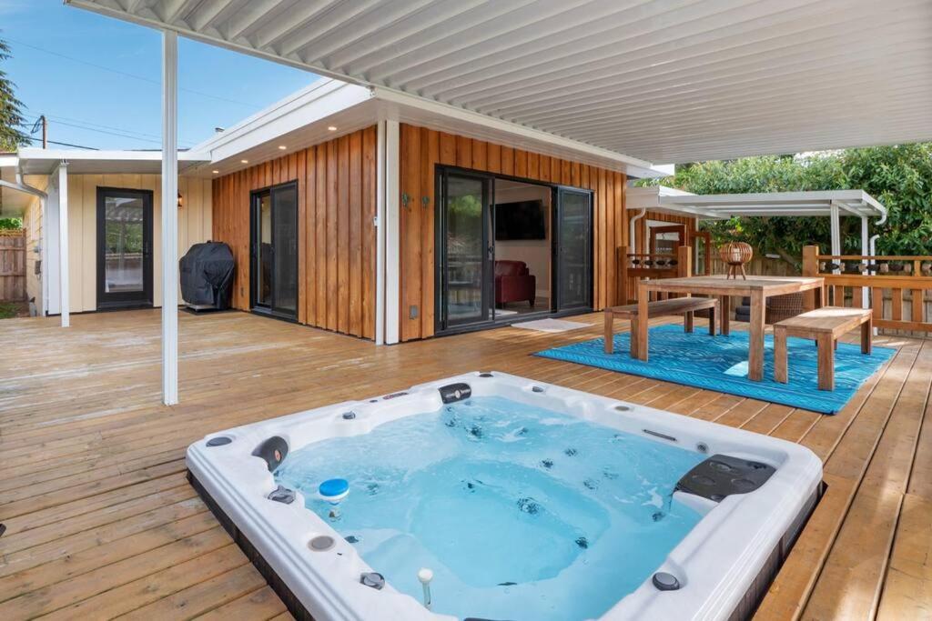 a hot tub on the deck of a house at Tranquil private house w hot tub steps to beach. in Gibsons