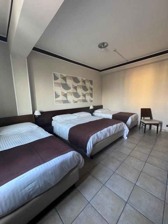 Postel nebo postele na pokoji v ubytování Hotel Vittoria