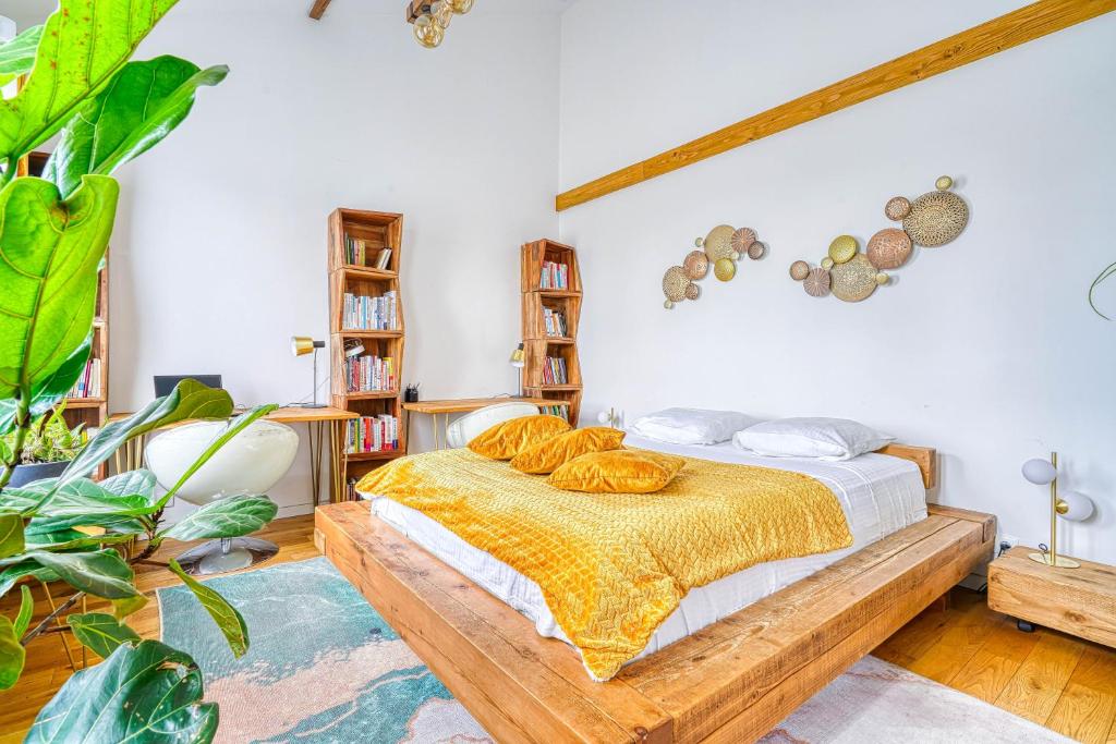 a bedroom with a bed with bread on it at Greg & Theo's in Fontenay-sous-Bois