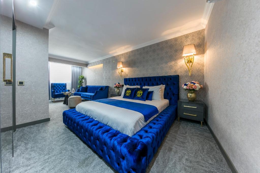 a bedroom with a blue bed with a blue couch at Grand Gedikpasha Hotel in Istanbul