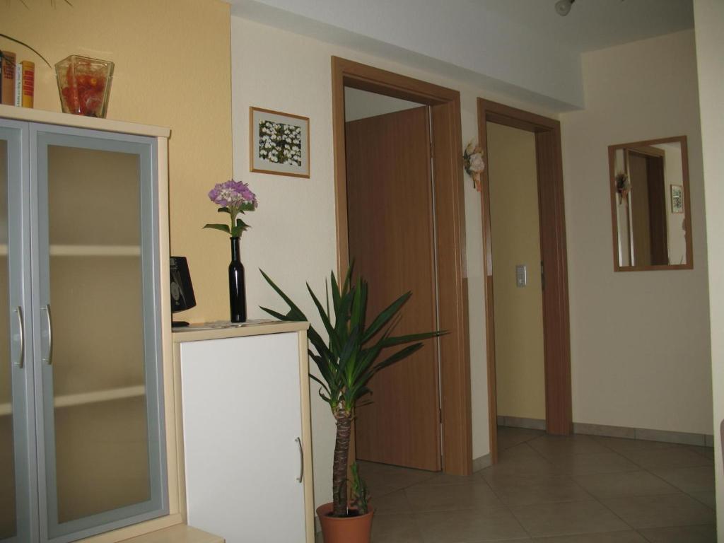 a room with a door and a vase with flowers in it at Haus Klara in Detzem