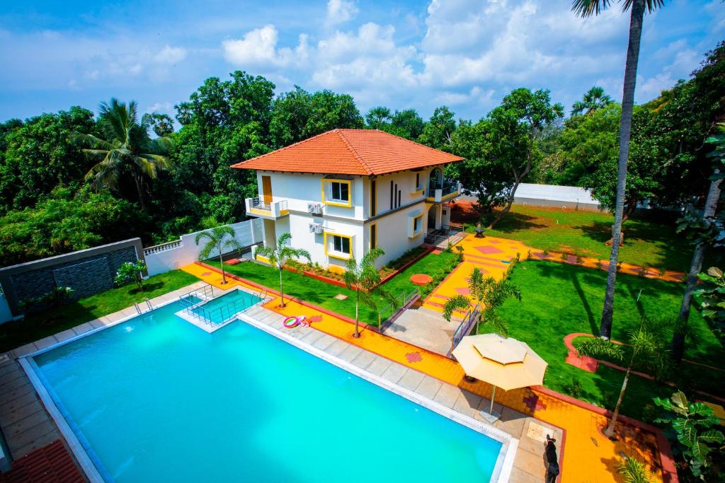 an aerial view of a house with a swimming pool at Queens Paradise Estate Resort in Puducherry