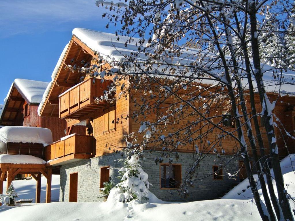 a building with snow on the side of it at Chalet Robin (6 personnes) in La Lechere