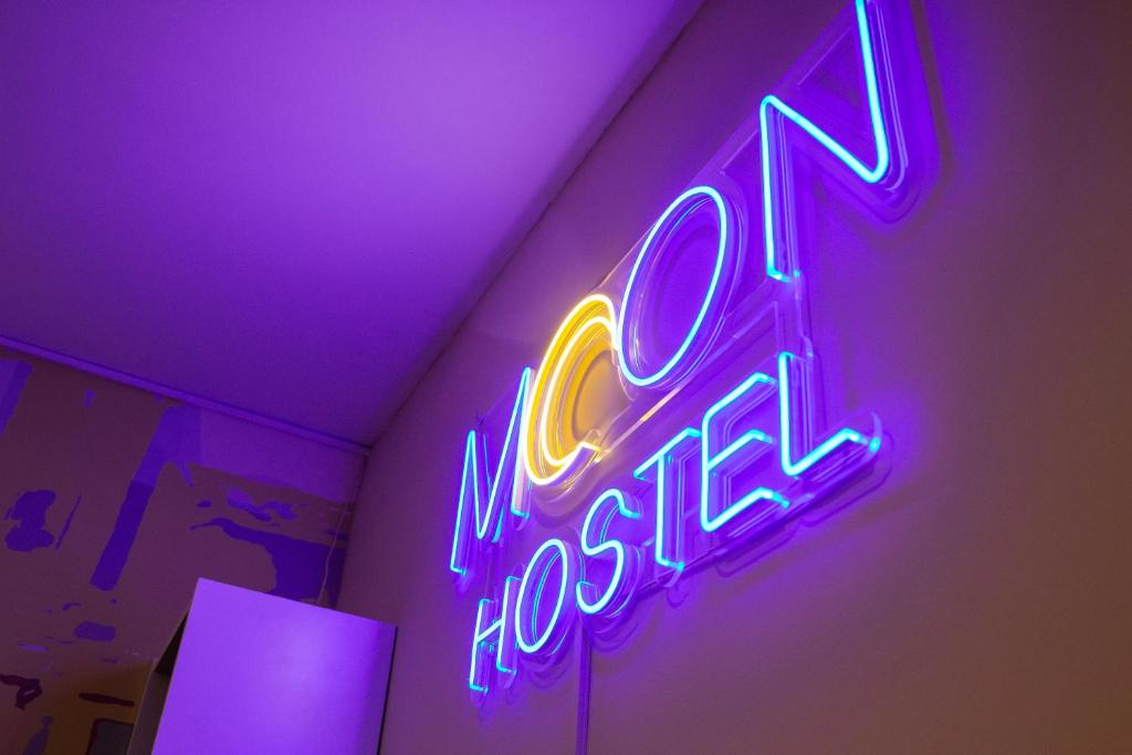a neon sign that says no interest on a wall at Moon Hostel Wrocław in Wrocław
