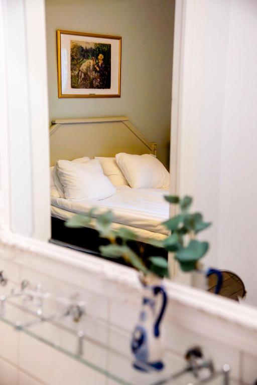 A bed or beds in a room at Park Hotel Linköping Fawlty Towers