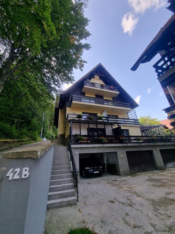 a building with stairs leading up to it at Apartament Kalinderu K2 Busteni in Buşteni