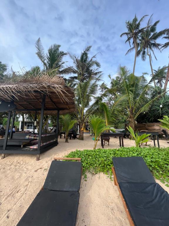 a resort with black mats on the beach at Sabine Holiday Resort and Restaurant in Matara