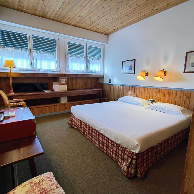 Postel nebo postele na pokoji v ubytování Hotel Miramonti