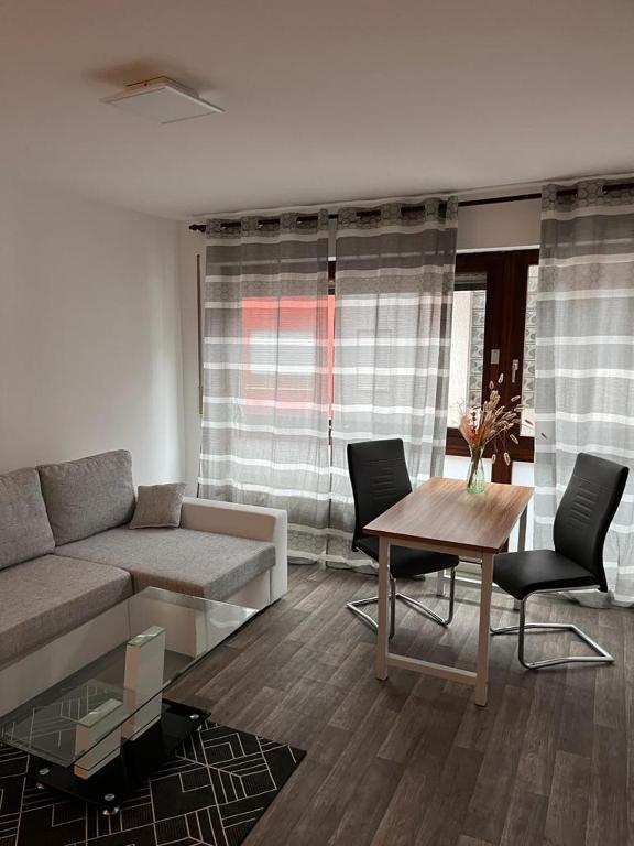 a living room with a couch and a table at Wohnungen bei Post in Hünfelden
