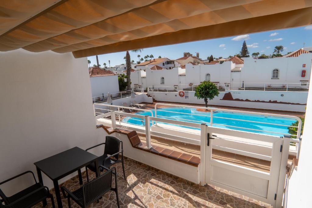 a view from the balcony of a villa with a swimming pool at Las Casitas de Corralejo in Corralejo