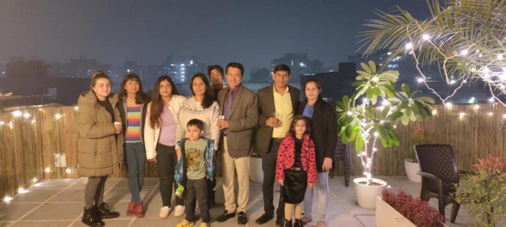 a group of people posing for a picture on a rooftop at Minato Homz in Gurgaon
