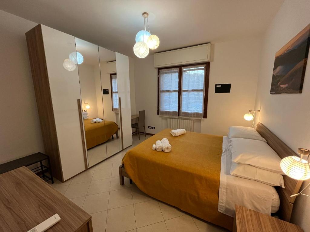 1 dormitorio con 1 cama grande y espejo en Appartamento Tufo - 10min dalla Rocchetta Mattei, en Vergato
