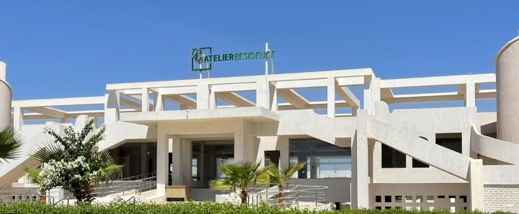 a white building with a sign on top of it at A Residence - Superior One Bedroom Aparthotel in Sharm El Sheikh