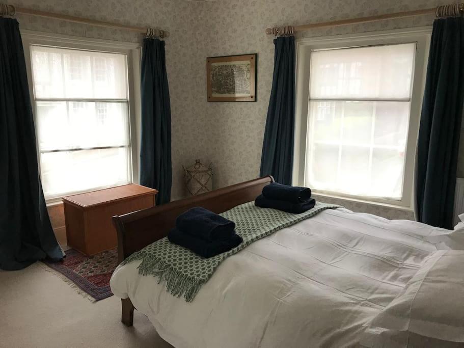 a bedroom with a bed with two blue towels on it at Charming property in the heart of Midhurst in Midhurst