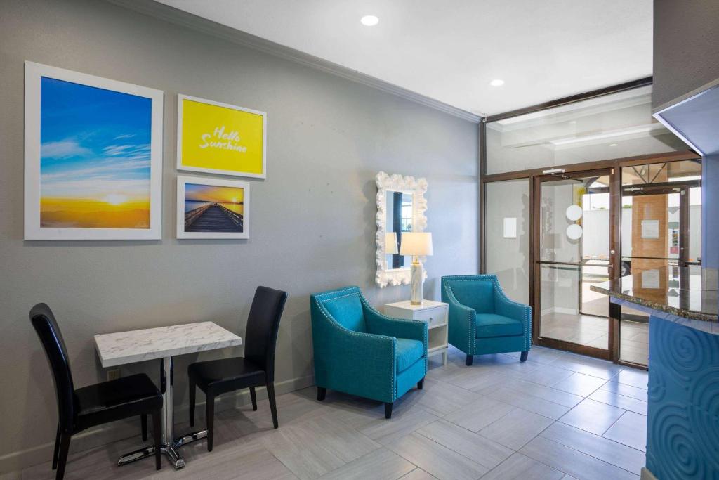 a waiting room with blue chairs and a table at Days Inn by Wyndham Lonoke in Lonoke