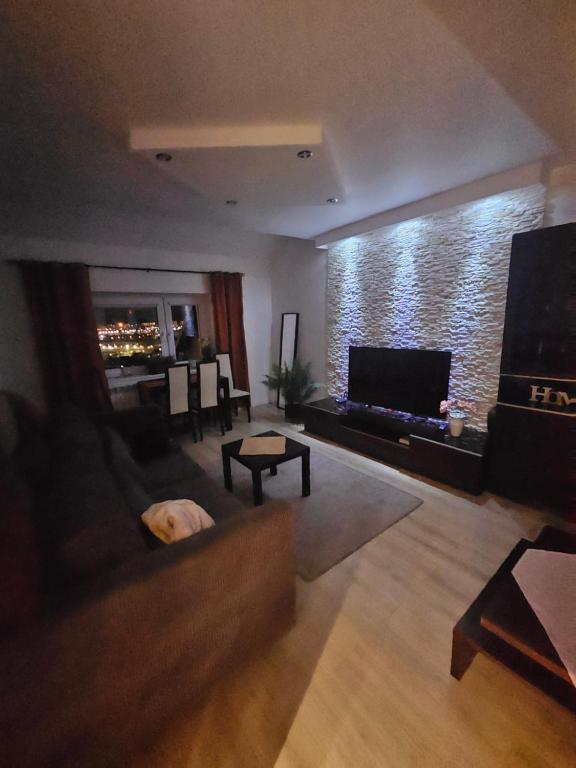 a living room with a couch and a flat screen tv at Apartament Panorama Miasta in Gdynia