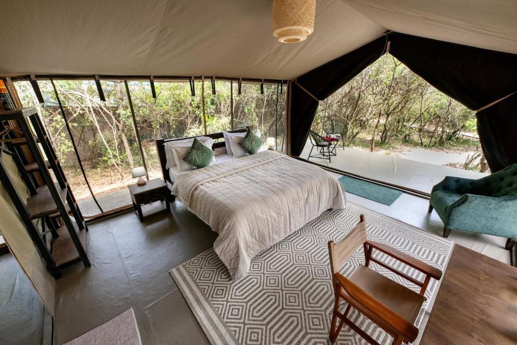 a bedroom with a bed in a tent at Olkinyei Mara Tented Camp in Talek