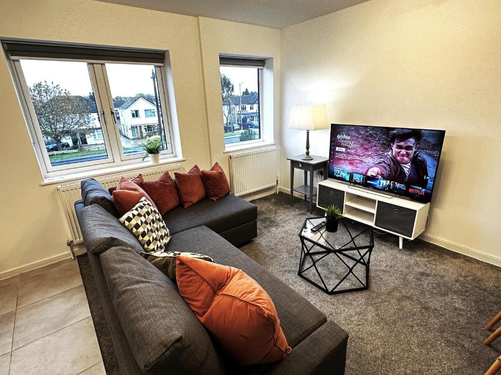 een woonkamer met een bank en een flatscreen-tv bij Walnut Flats-F4, 2-Bedroom with Ensuite - Parking, Netflix, WIFI - Close to Oxford, Bicester & Blenheim Palace in Kidlington