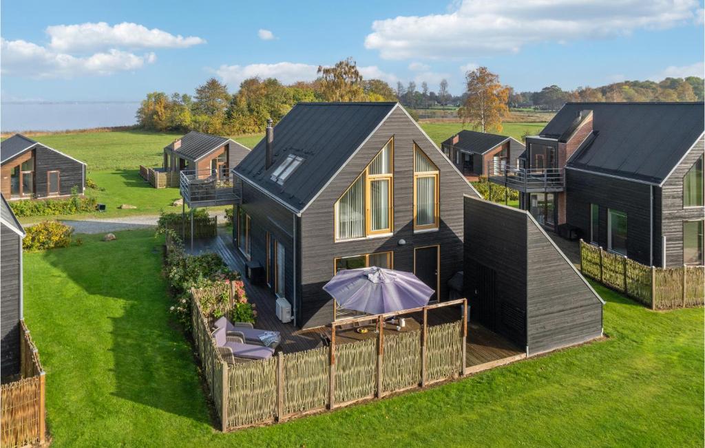 an aerial view of a house with a fence at Gorgeous Home In Stubbekbing With Kitchen in Stubbekøbing