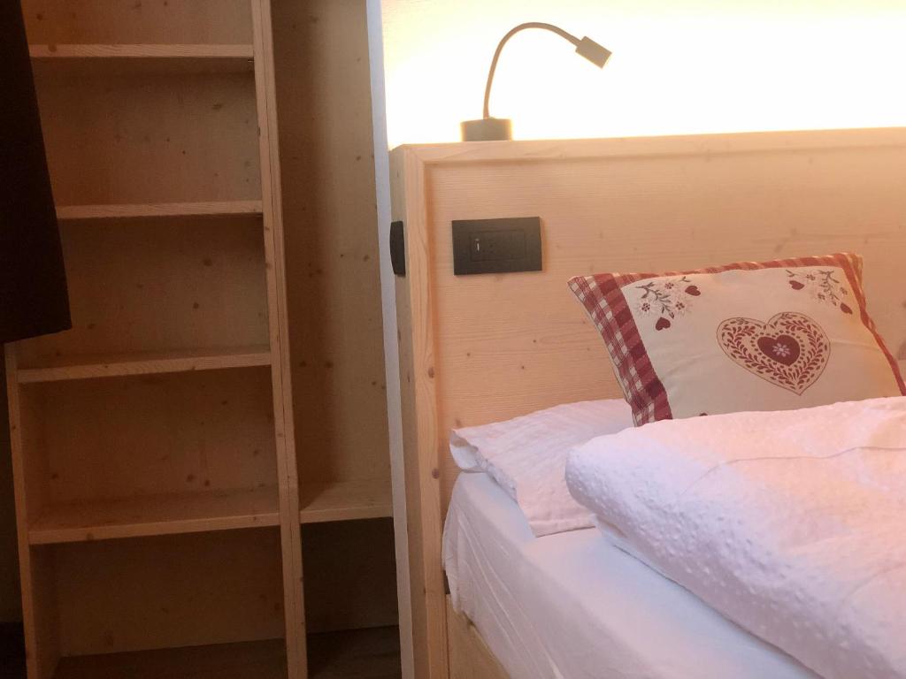 B&B Tilde في تيزيرو: غرفة نوم مع سرير ورف كتاب