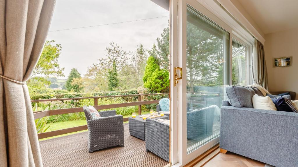 a room with a balcony with a sliding glass door at The Eyrie in Ashbourne