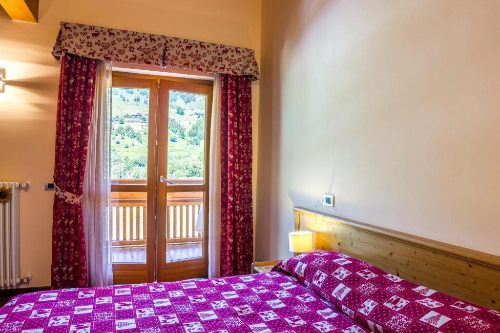 Postel nebo postele na pokoji v ubytování Albergo Punta Zerbion