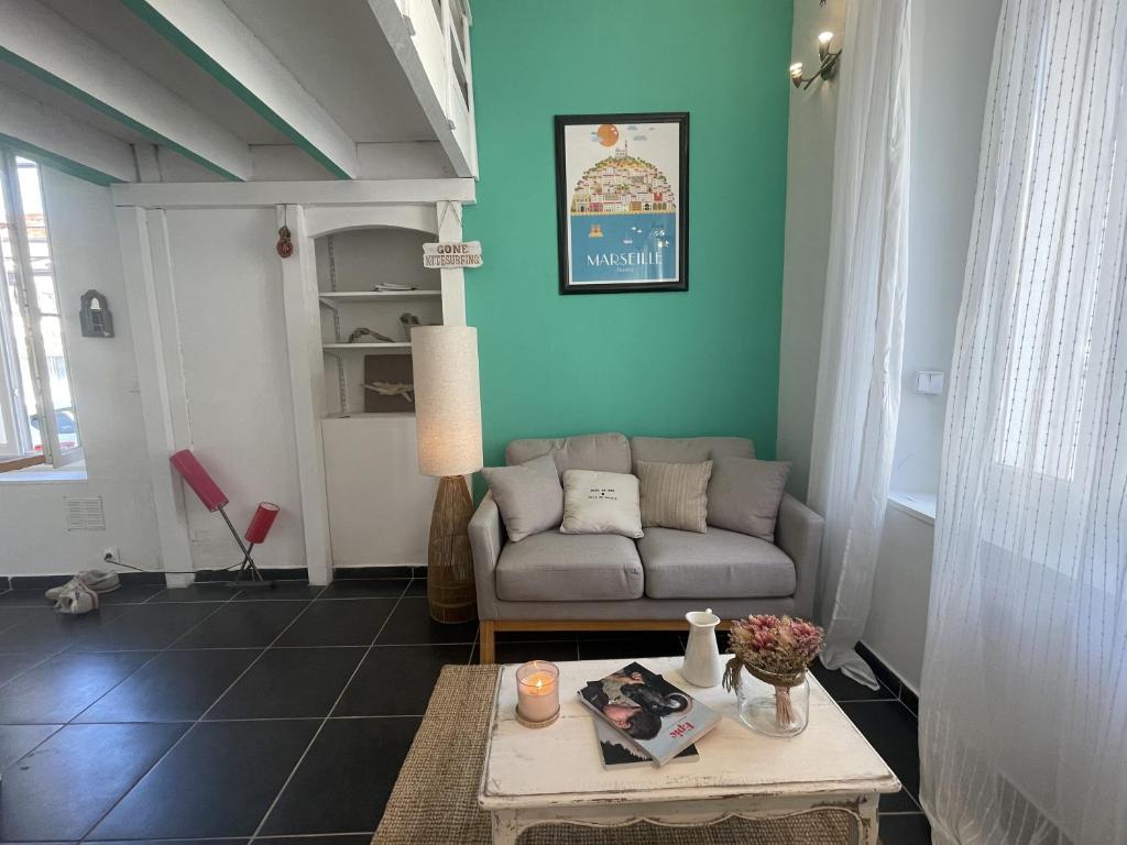 a living room with a couch and a table at Le cabanon de Manon in Marseille