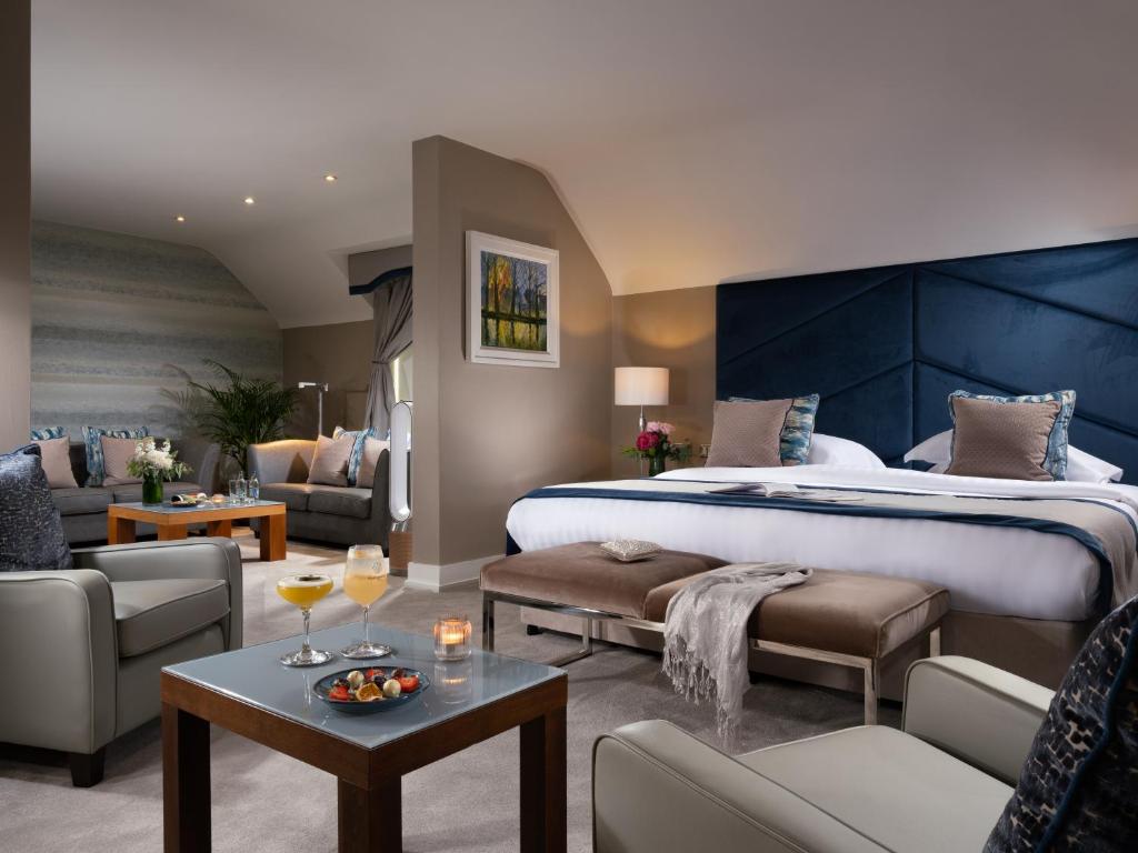 a bedroom with a large bed and a living room at Castleknock Hotel in Blanchardstown