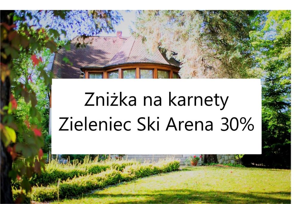a house with a sign that reads zichenka nkancy excellence six arena at Pensjonat Pod Świerkami in Polanica-Zdrój