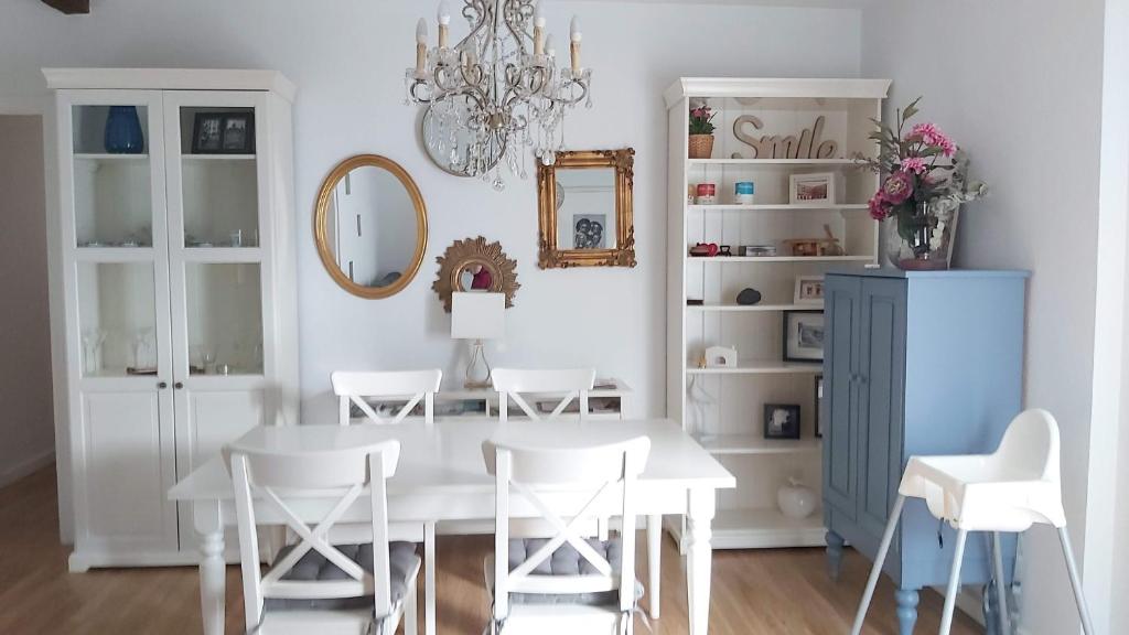 uma sala de jantar com uma mesa branca e cadeiras brancas em Casa De Los Espejos em Córdoba
