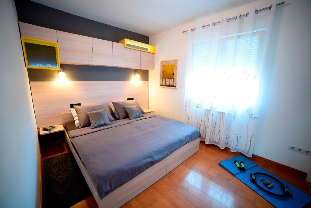 a bedroom with a large bed and a window at Zagreb Lodge Apartman 1 in Zagreb