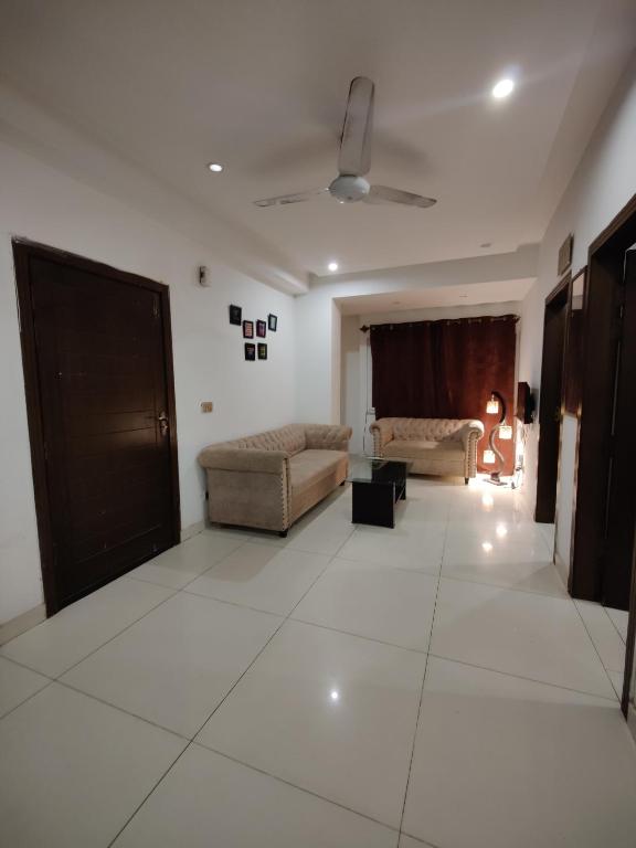 a living room with two couches and a couch at 2 Bedrooms Standard Apartment Islamabad-HS Apartments in Islamabad