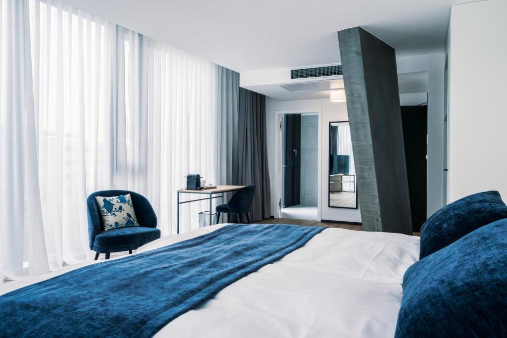 Postel nebo postele na pokoji v ubytování YParc Hôtel