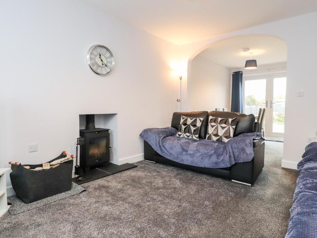 a living room with a couch and a fire place at 3 Thrimby Court in Morecambe
