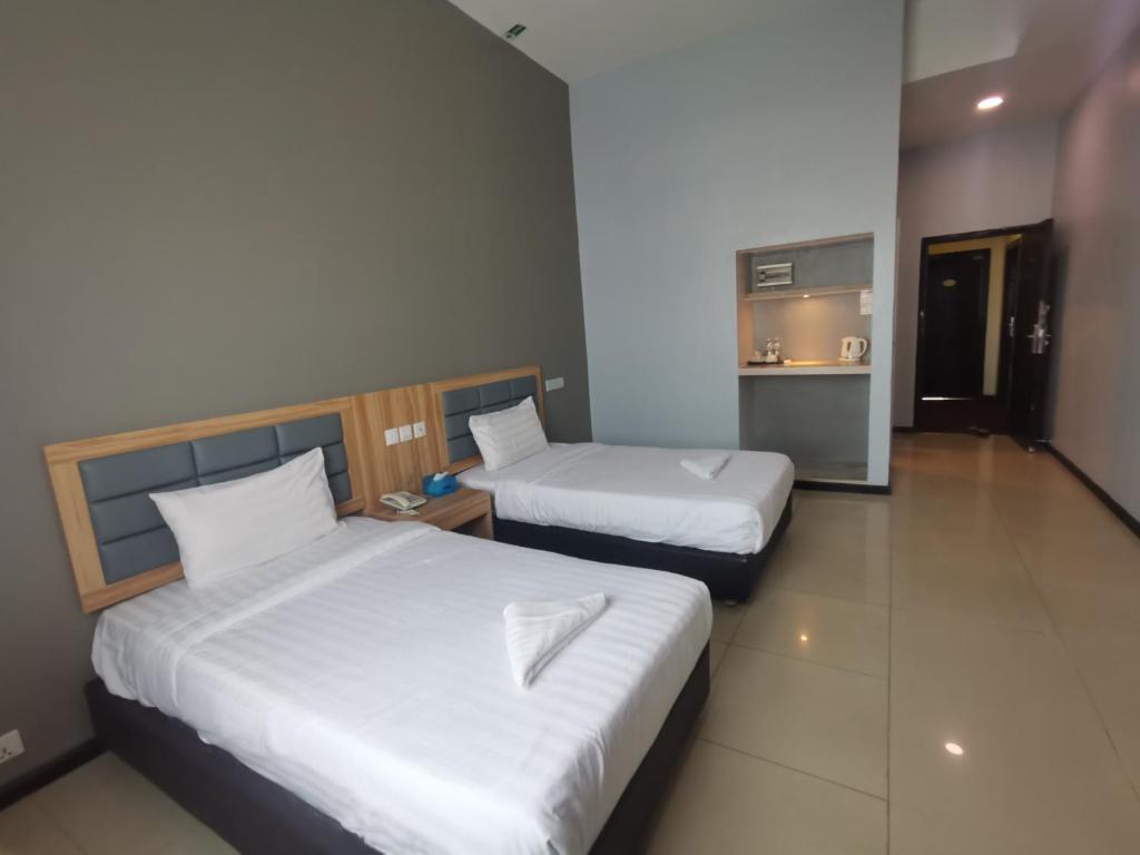 Postel nebo postele na pokoji v ubytování Kingston Executive Hotel