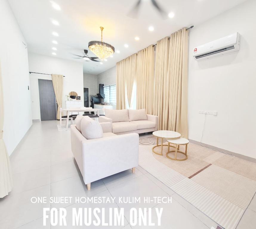 Sala de estar blanca con sofá y mesa en One Sweet Homestay Kulim Hi-Tech utk Msliim shj en Kulim
