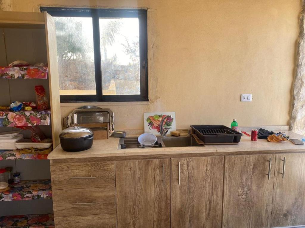 a kitchen with a counter top and a window at Amman landscape farm in Amman